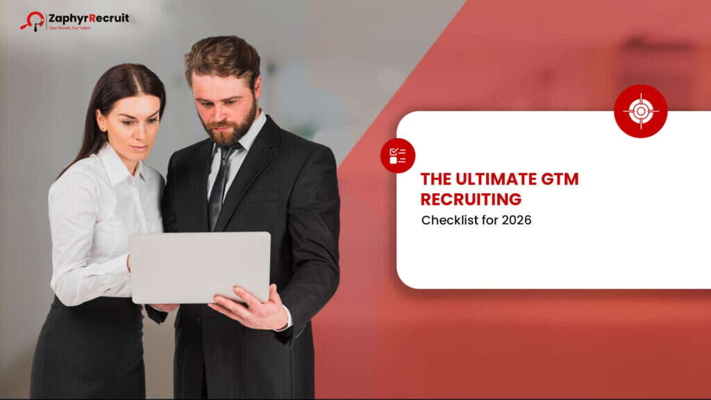 Two recruiters reviewing a laptop beside a title card reading The Ultimate GTM Recruiting Checklist for 2026.