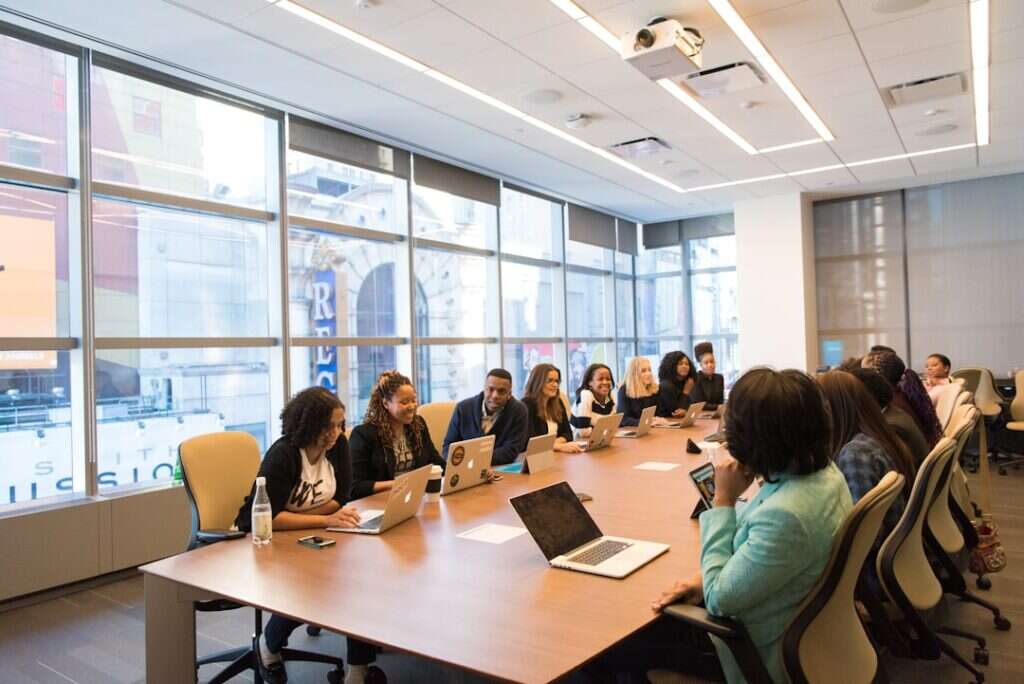 Cross-functional team meeting around a long conference table