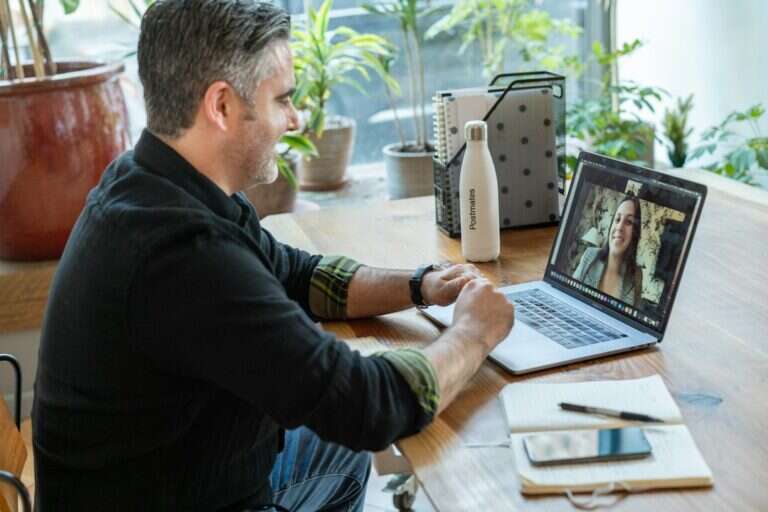 Recruiter running a screening call over video on a laptop