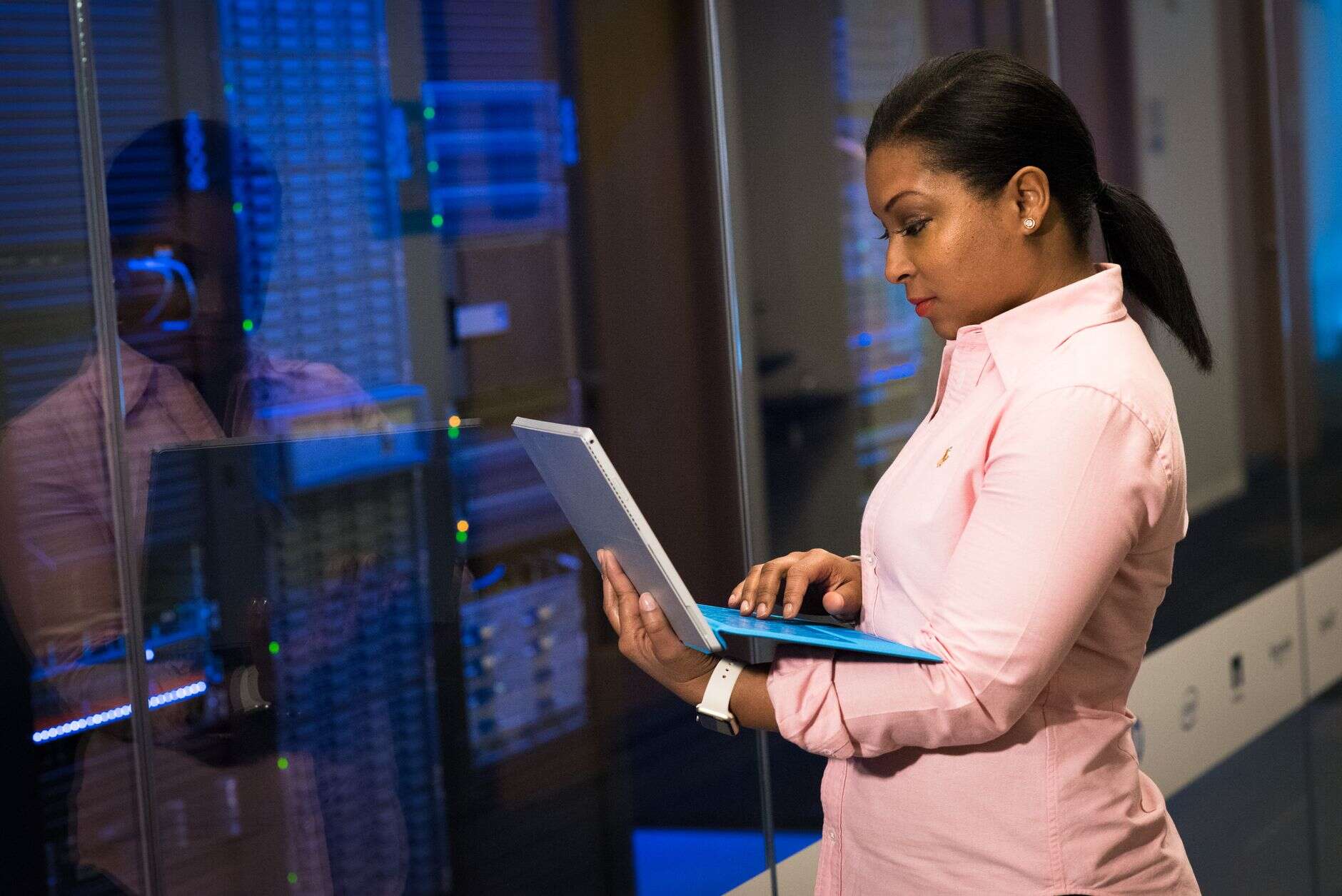 Engineer working on a laptop in a server room
