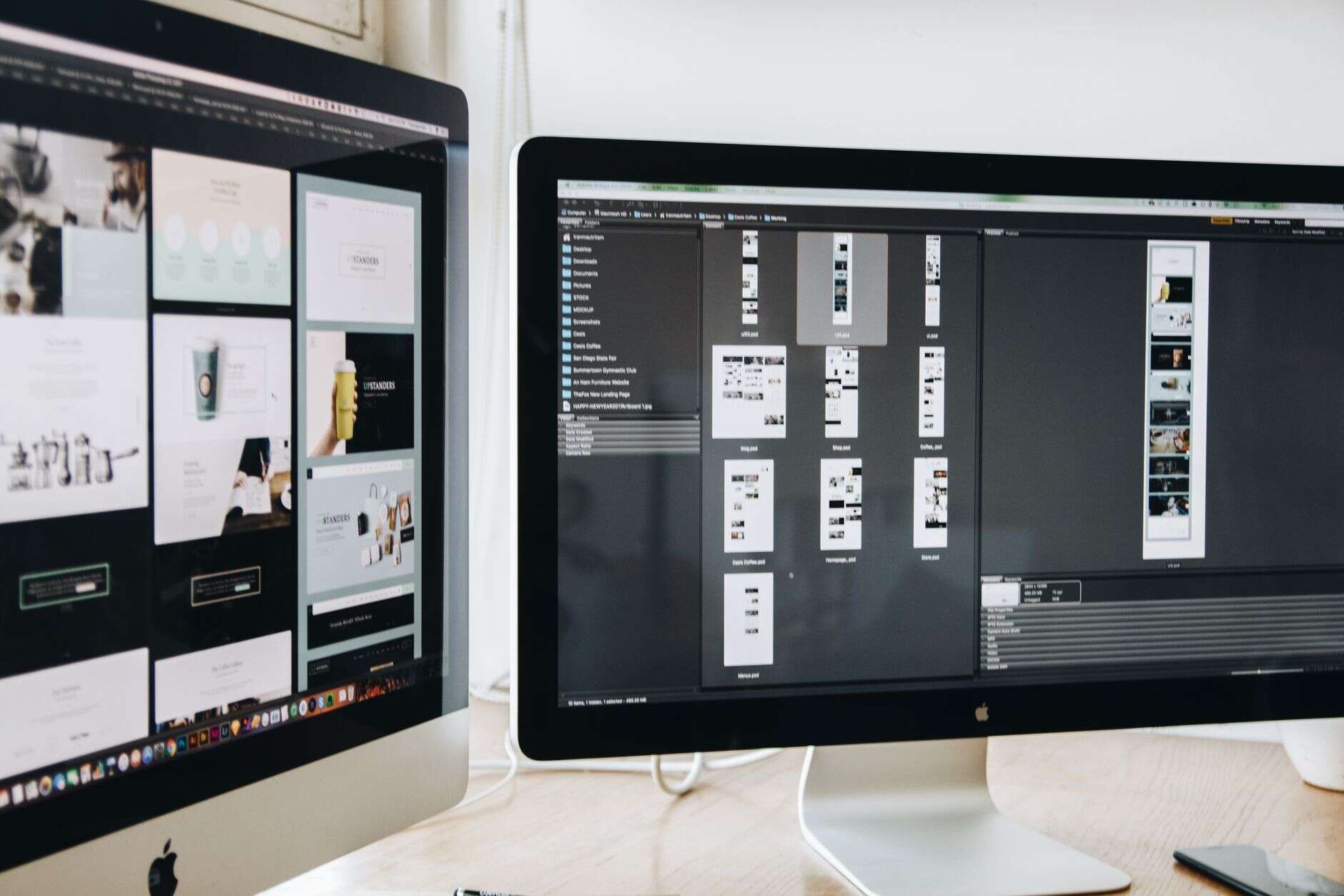 Webflow developer working across two monitors, one showing website page designs