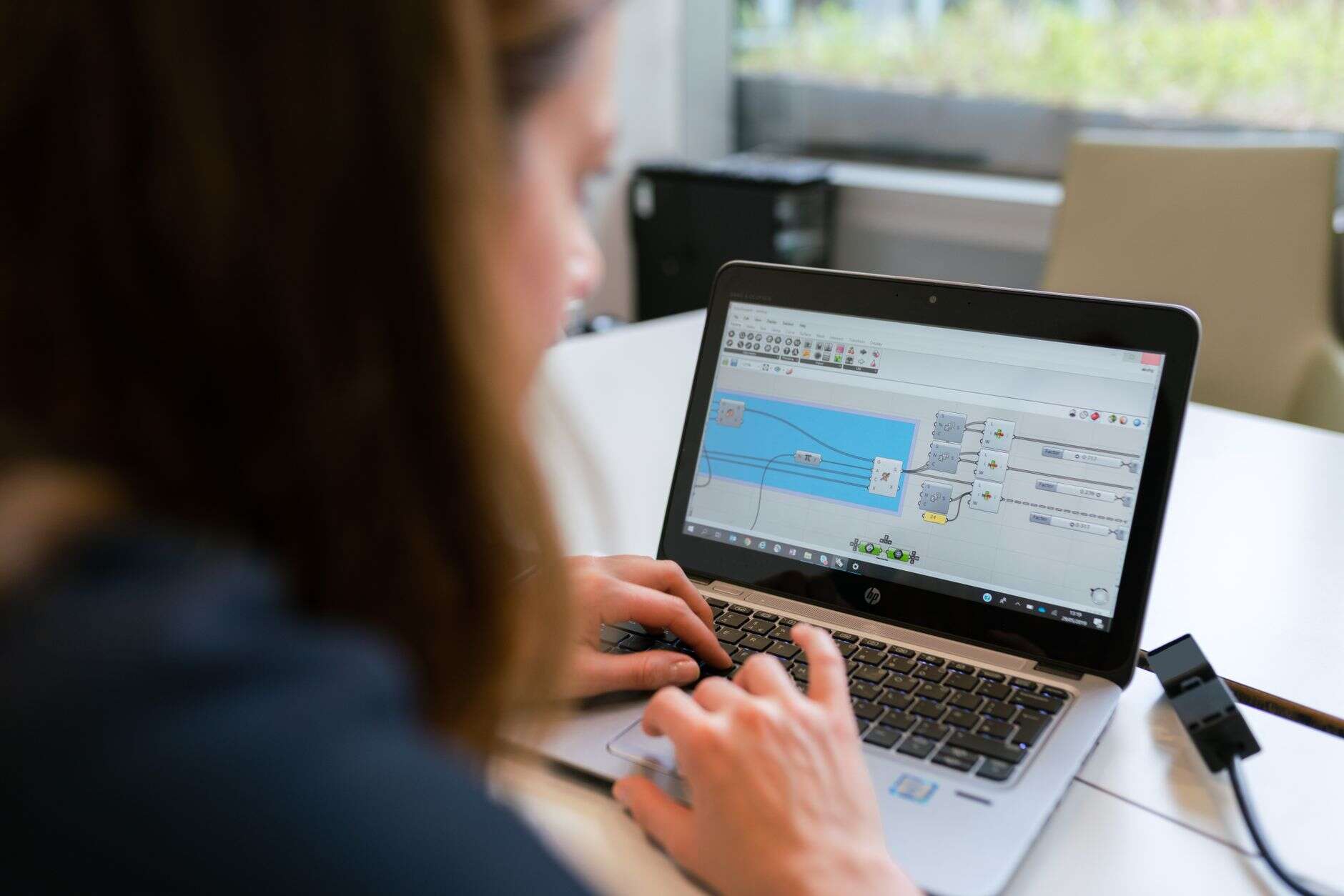 Automation specialist building a workflow on a laptop