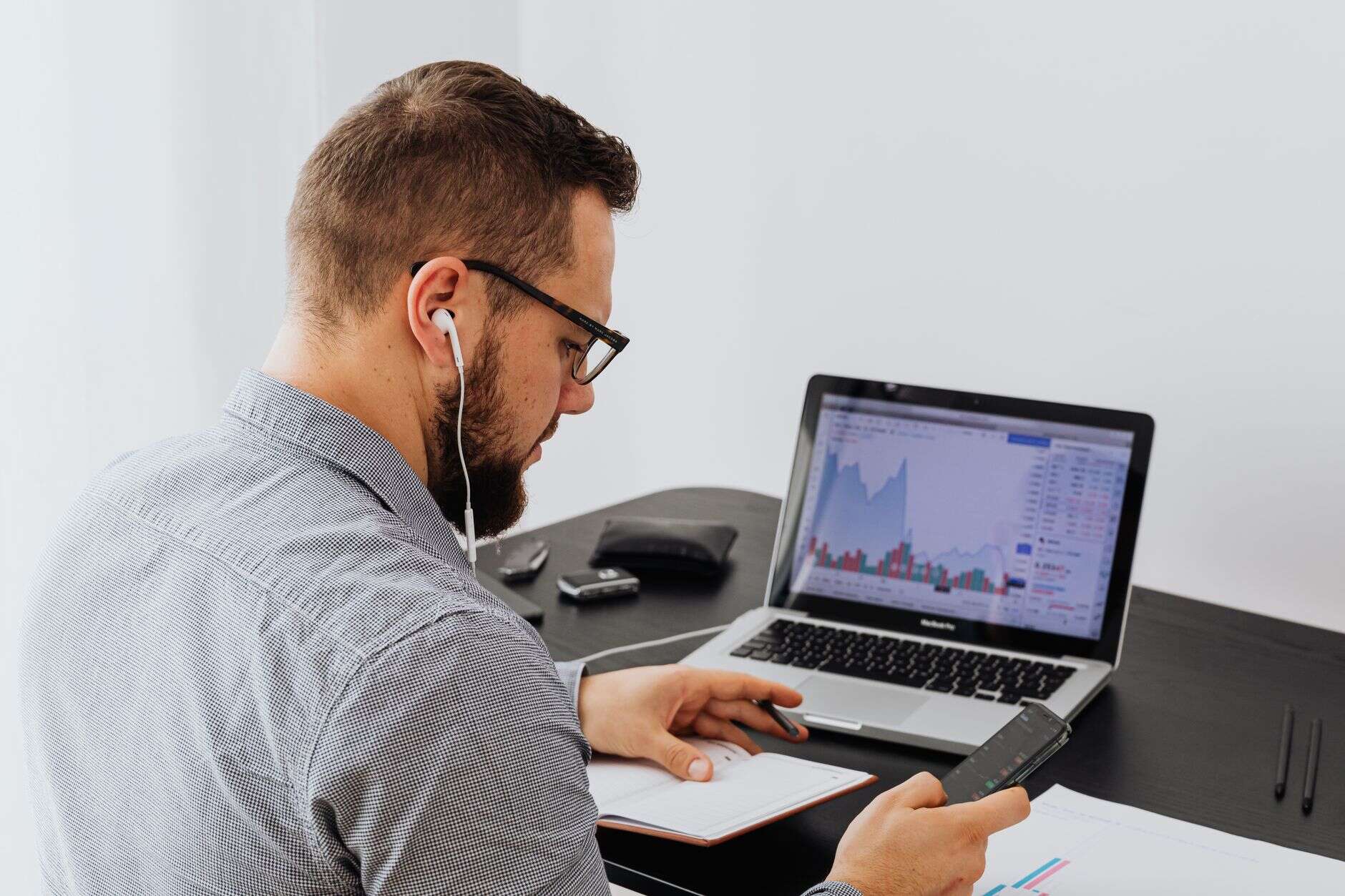 Data scientist reviewing charts on a laptop at a desk