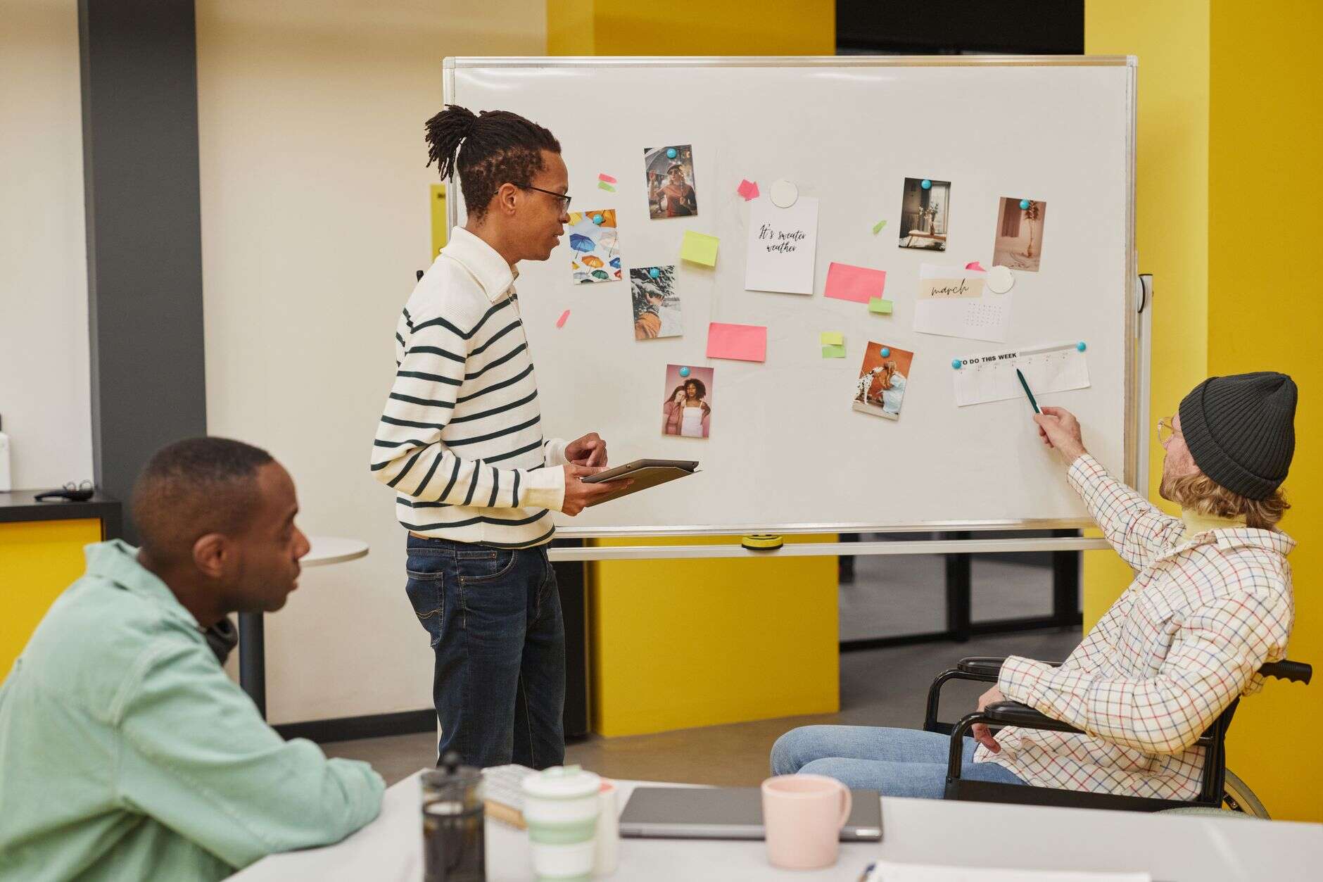 Brand team discussing images pinned to a whiteboard