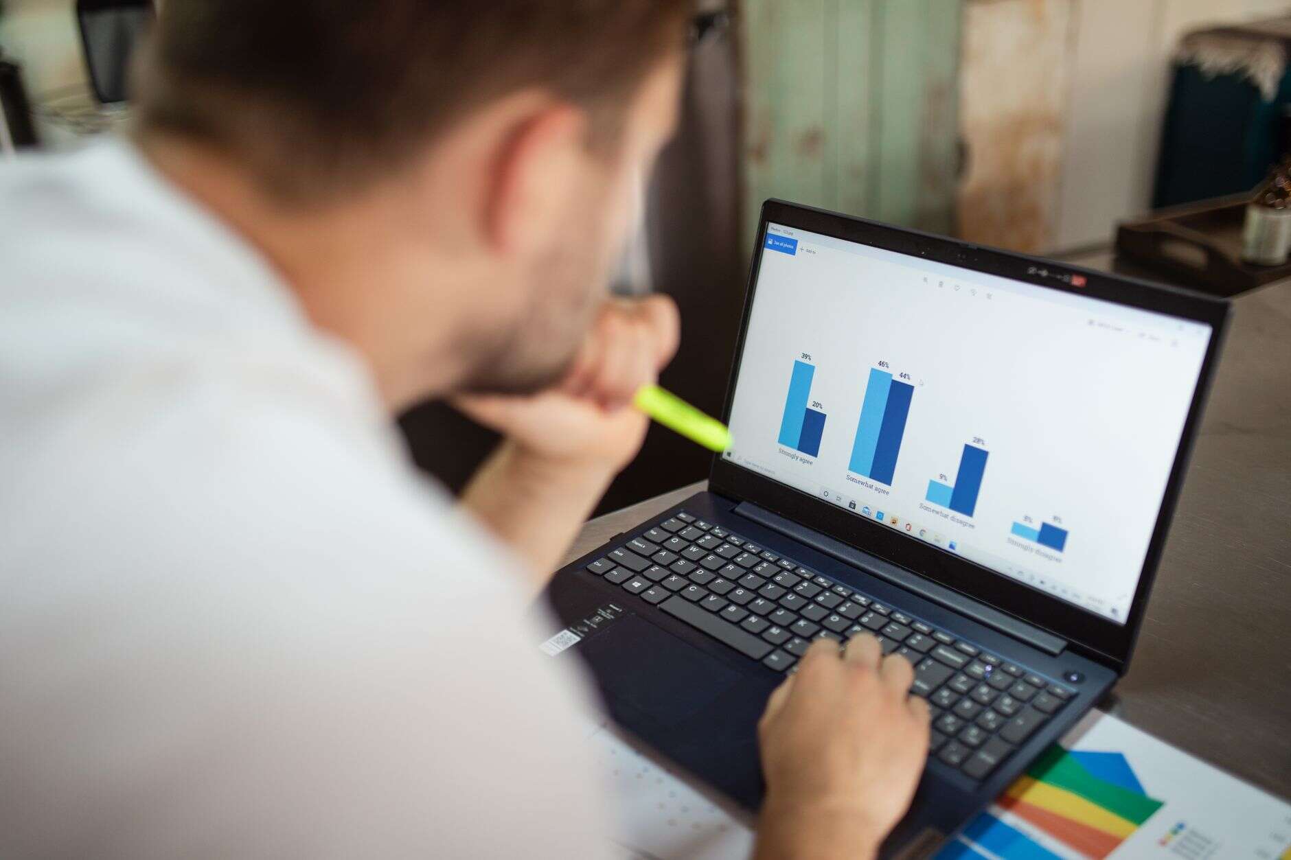 Analyst reviewing performance charts on a laptop