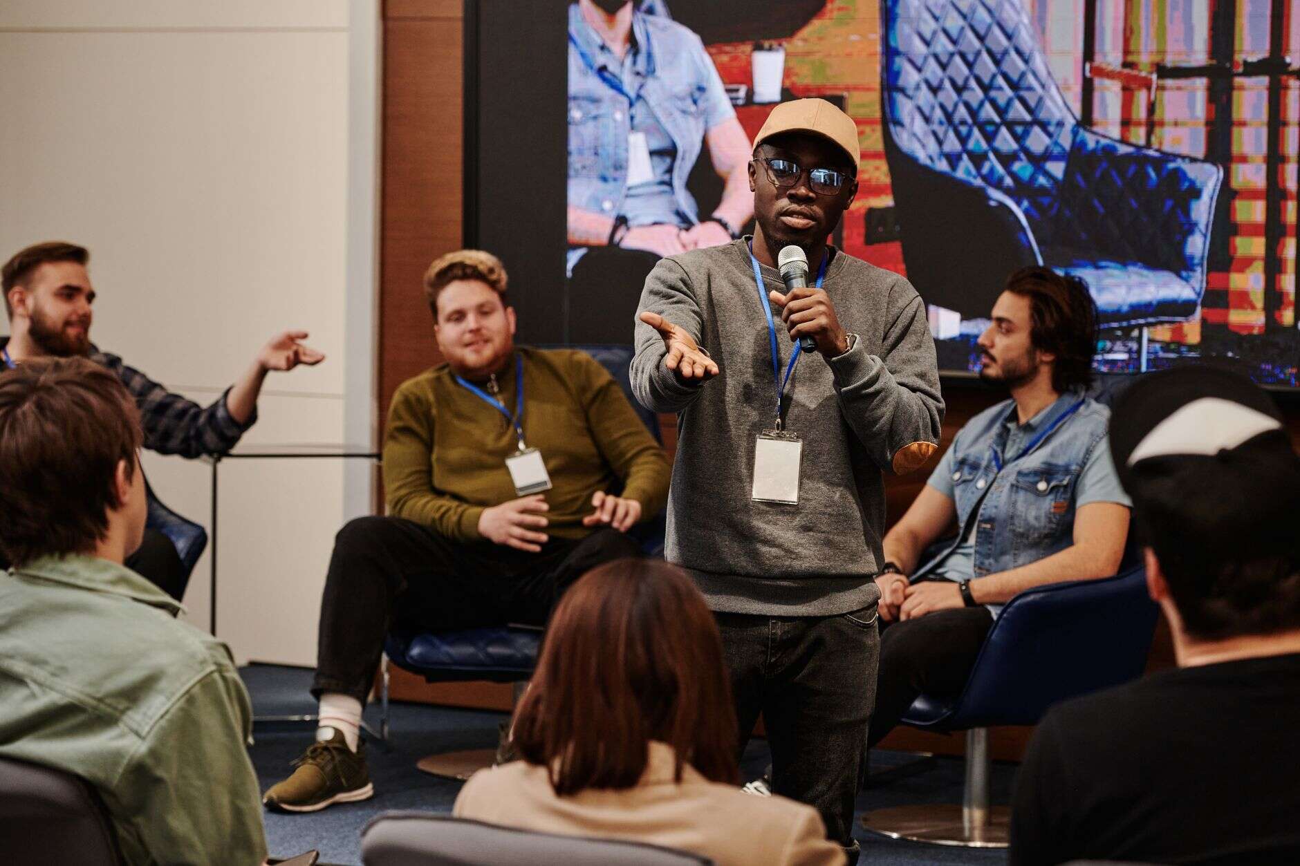 Community manager taking a question from a member at a community meetup