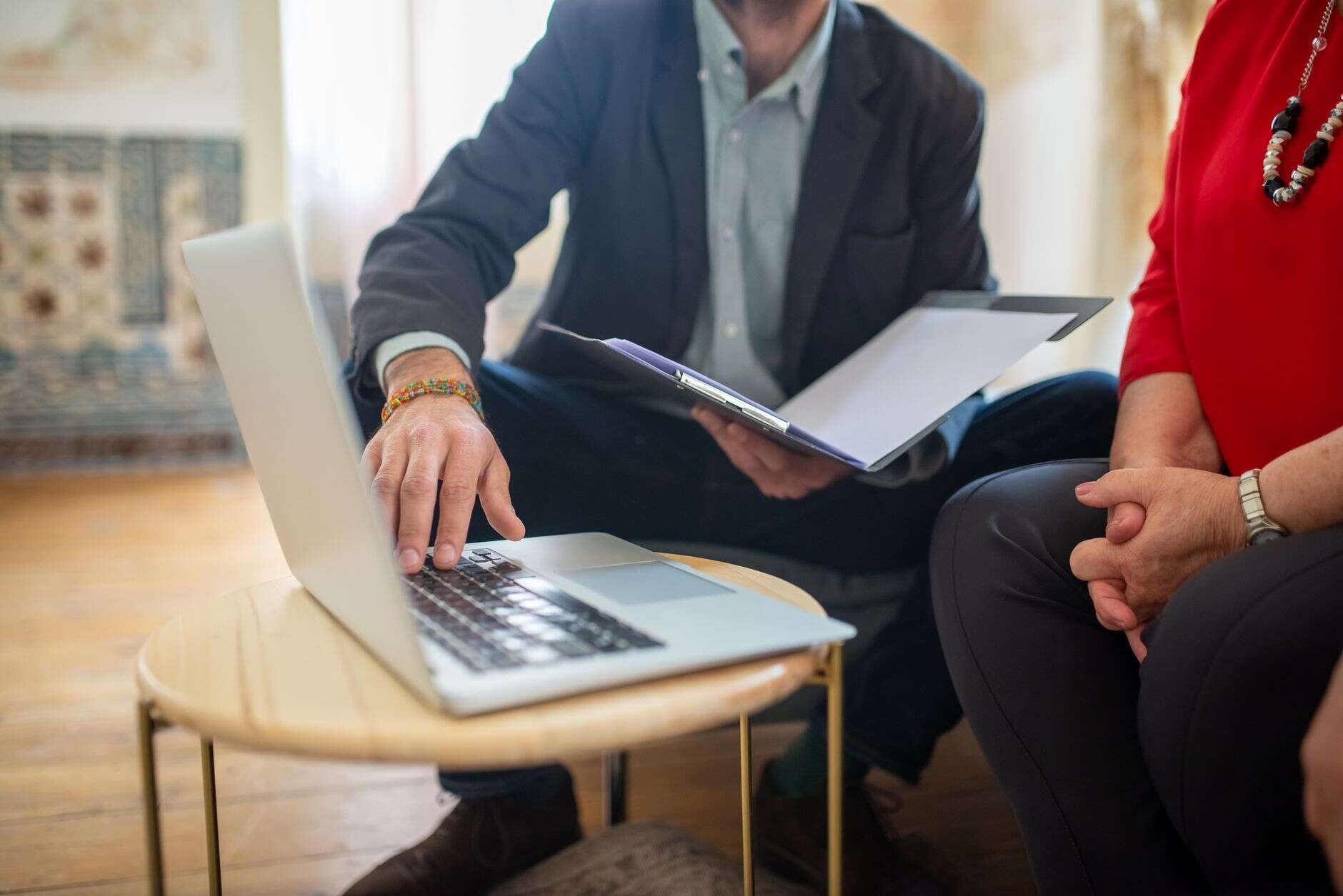 Pre-sales consultant walking a client through software on a laptop