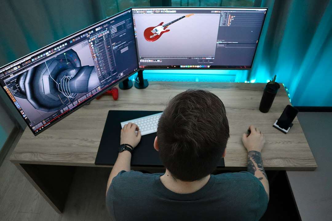 Motion designer working on a 3D animation across two monitors