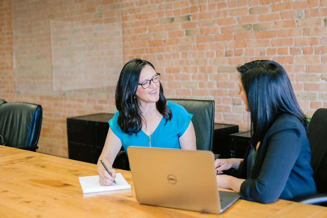 Account executive in a discovery meeting with a client across a table