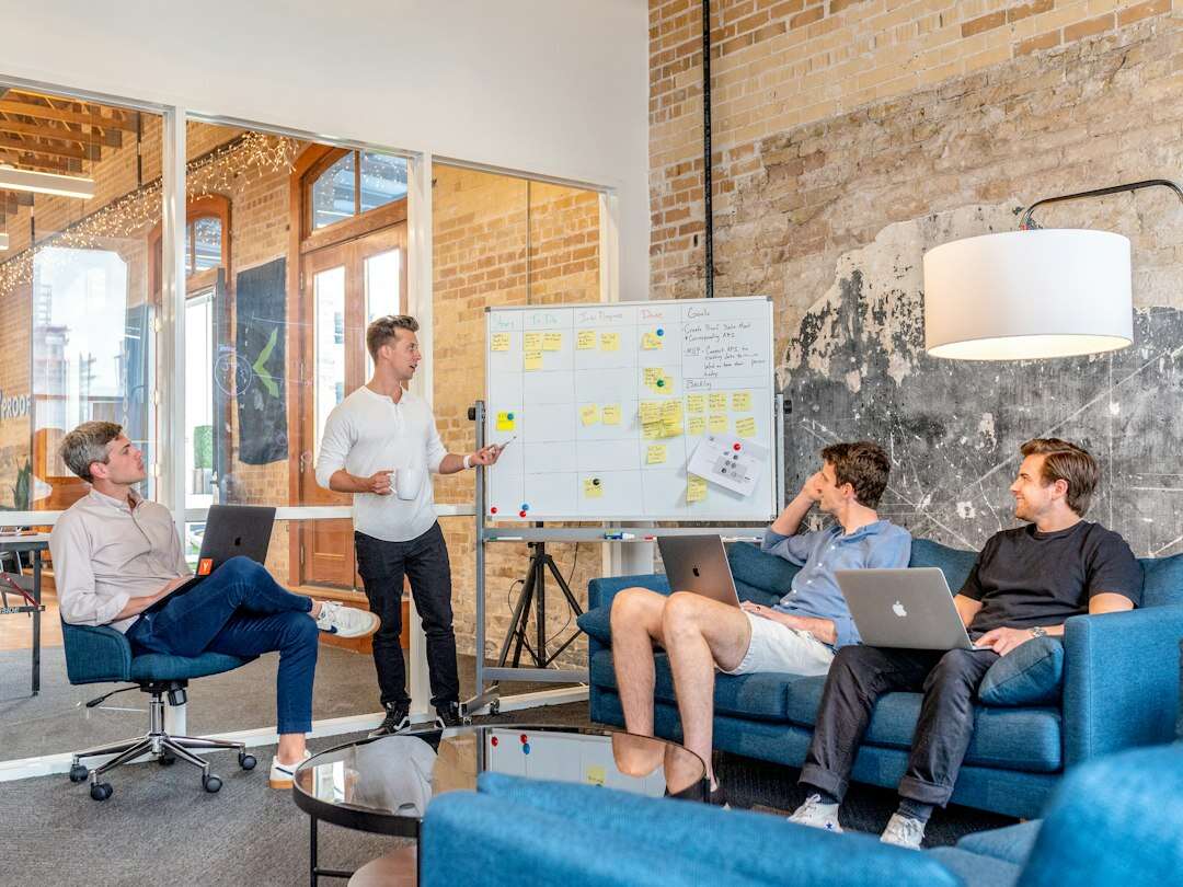 Marketing team planning a campaign around a whiteboard