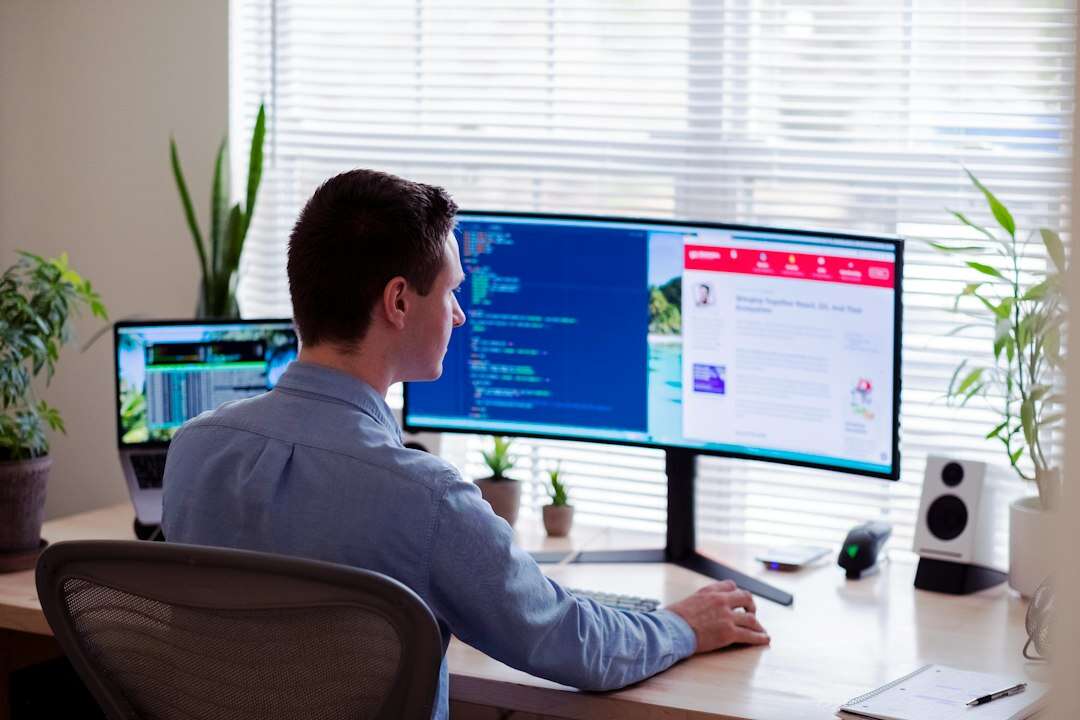 Web developer working on a site build at a curved monitor