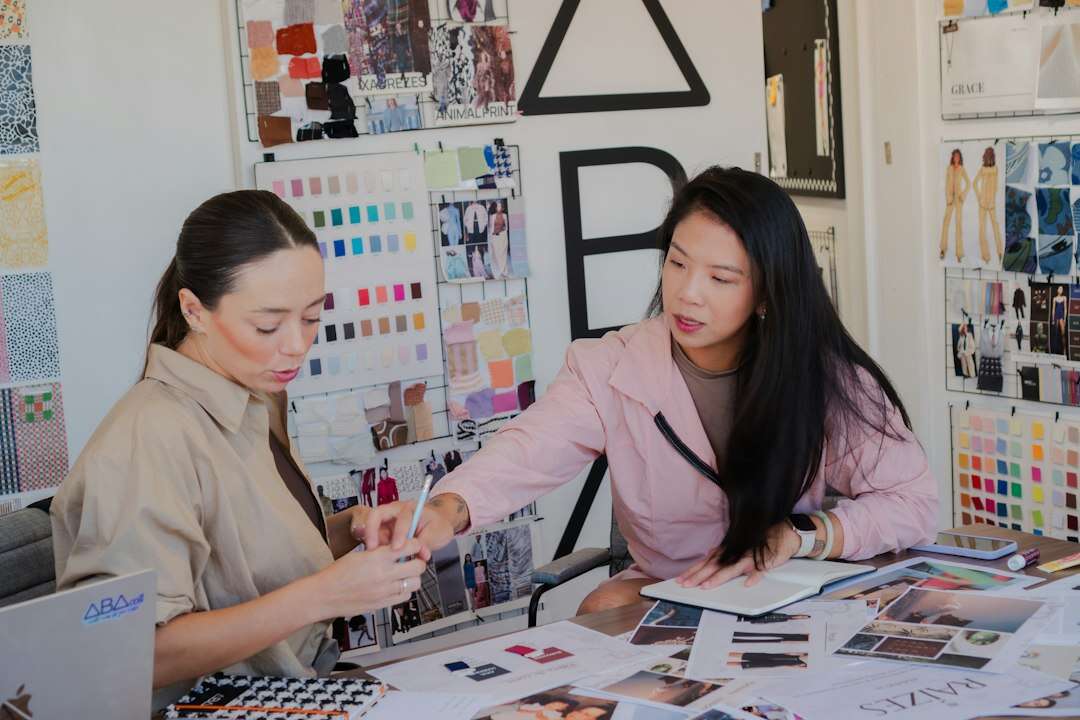 Creative director and a designer going through color swatches and mood boards at a studio table